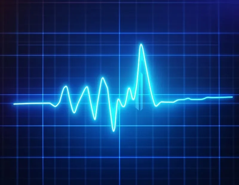 Cyfrowy wykres tętna w kolorze czerwonym na niebieskim tle